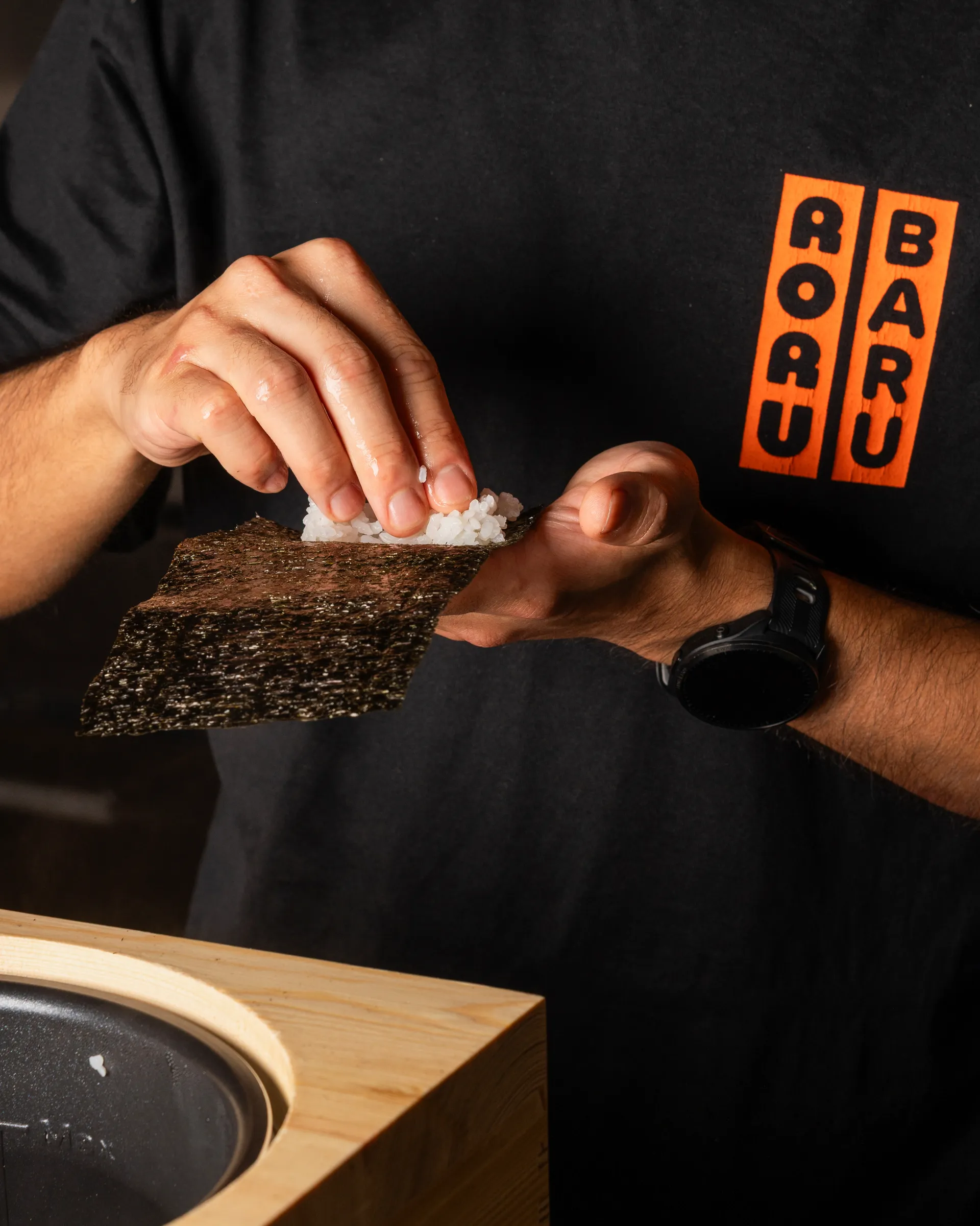 Close-up of a temaki hand roll being made with rice and crisp Japanese nori at RORUBARU