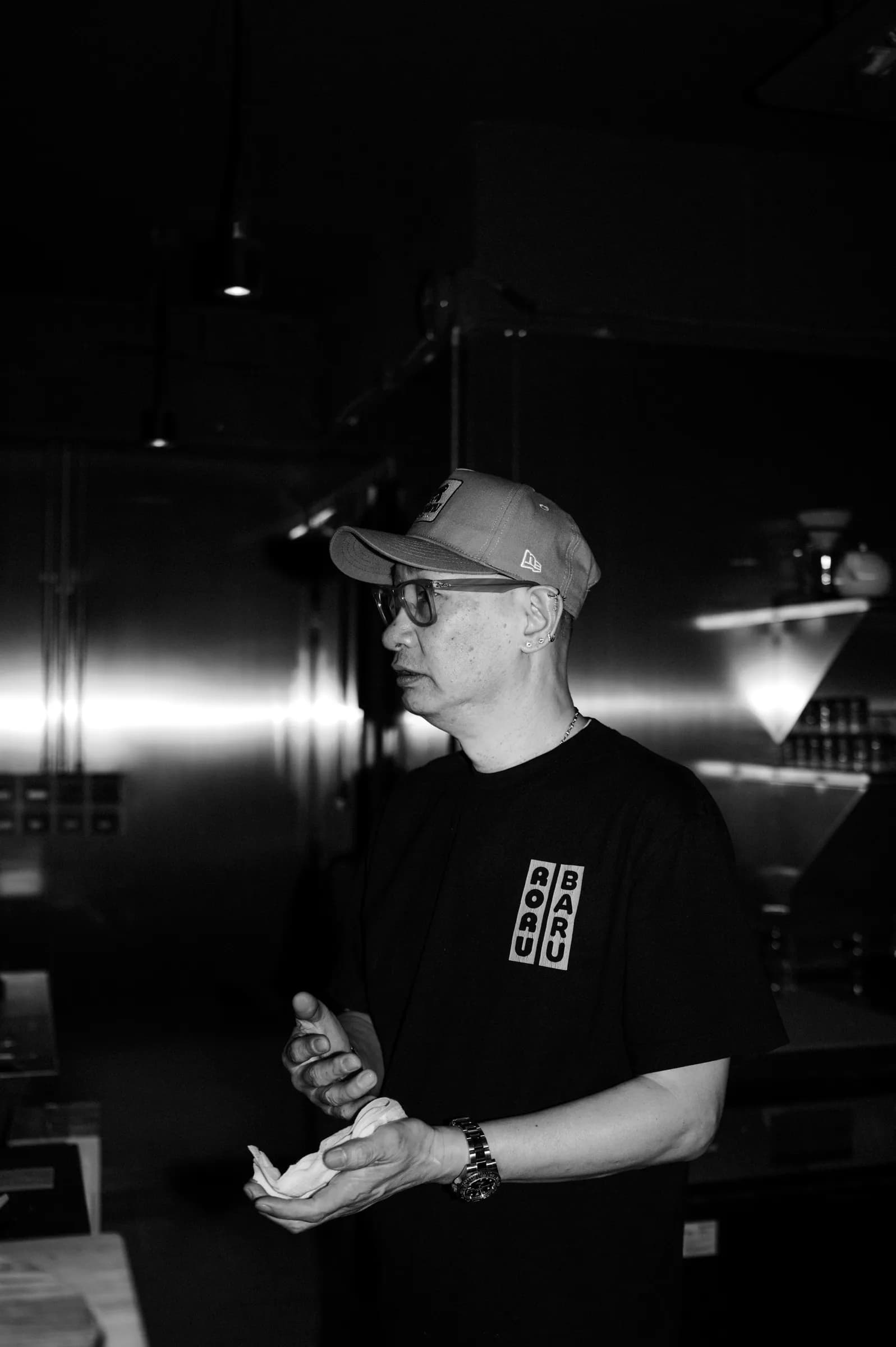 A RORUBARU team member in a Roru Baru tee at the hand roll counter in Wan Chai, Hong Kong